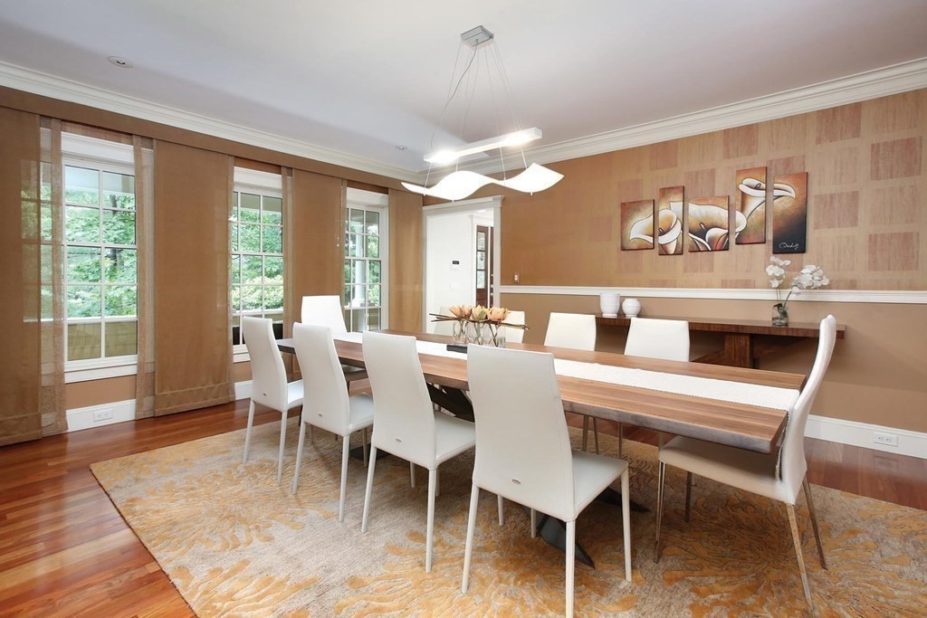 10 Cutter's Bluff Weston, MA 02493 - Photo 12 of 34 a dining room with wooden floor a chandelier a wooden table and chairs