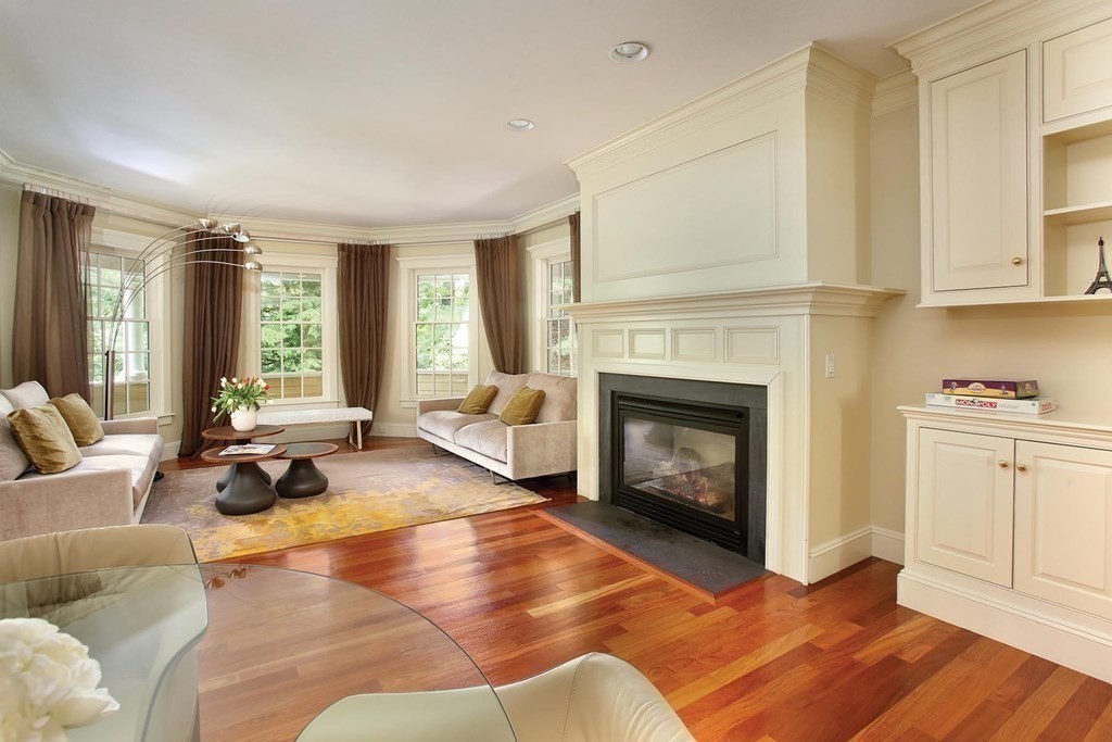 10 Cutter's Bluff Weston, MA 02493 - Photo 13 of 34 a living room with furniture a fireplace and wooden floor