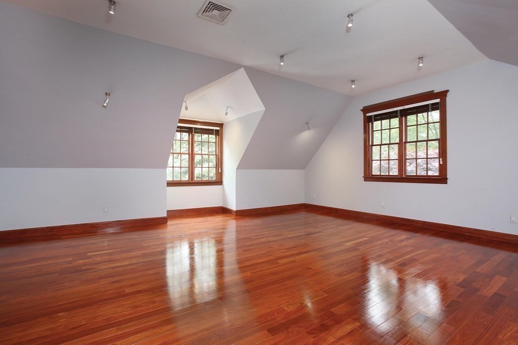 10 Cutter's Bluff Weston, MA 02493 - Photo 17 of 34 an empty room with wooden floor and windows