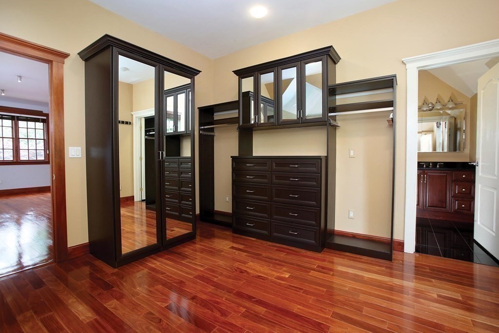 10 Cutter's Bluff Weston, MA 02493 - Photo 18 of 34 a view of hallway with wooden floor and stairs