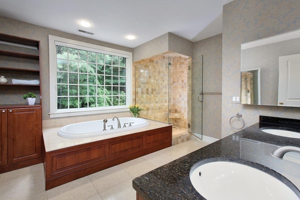 10 Cutter's Bluff Weston, MA 02493 - Photo 20 of 34 a bathroom with a granite countertop tub a sink and a large window