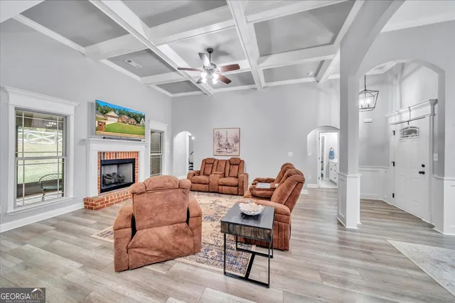 a living room with furniture a fireplace and a flat screen tv