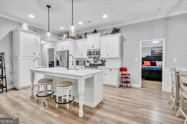 a kitchen with sink cabinets and wooden floor