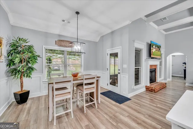 a view of a dining room with furniture window and wooden floor
