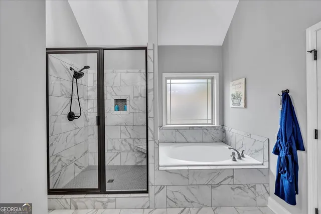 a en suite bathroom with a tub and mirror