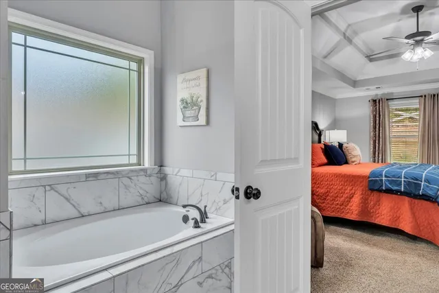 a bathroom with double vanity and a mirror