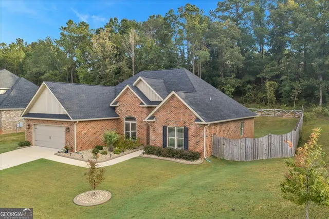aerial view of a house with swimming pool next to a yard