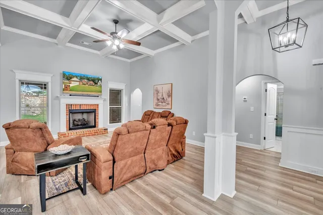 a living room with furniture fireplace and flat screen tv