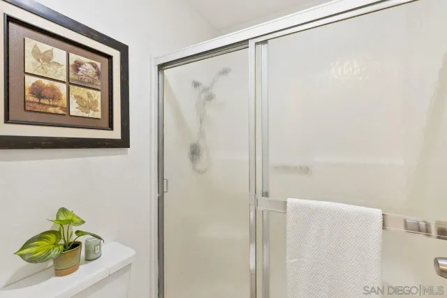 a bathroom with a shower curtain and a window