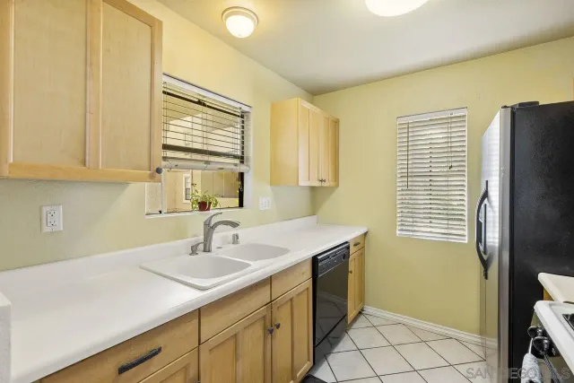 a kitchen with a sink cabinets and window