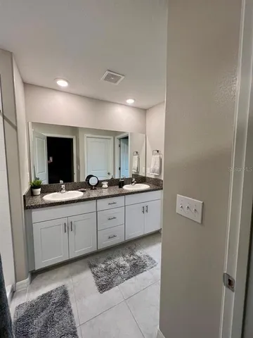 a large bathroom with a sink and a mirror