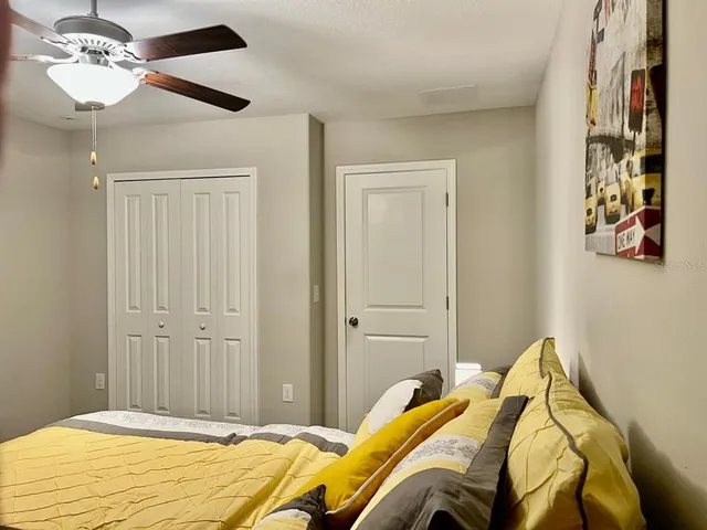 a bedroom with a bed and a chandelier