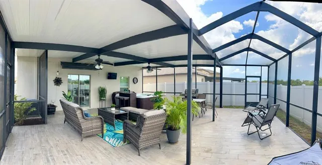 a view of a patio with a dining table and chairs