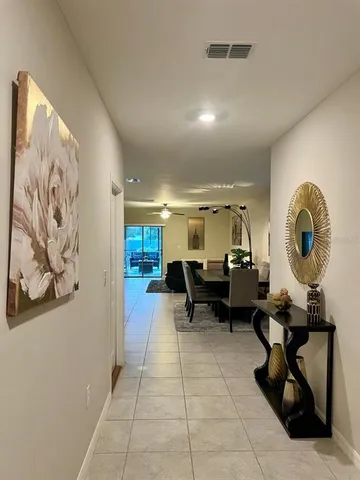 a lobby with furniture and a mirror