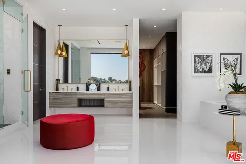 a kitchen with kitchen island granite countertop a refrigerator and a sink