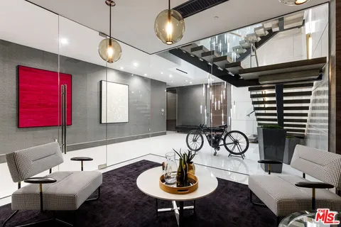 a living room with furniture and a ceiling fan