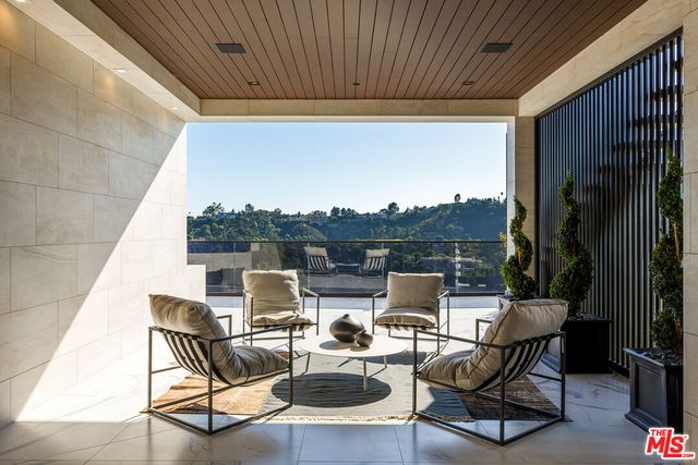 a roof deck with table and chairs
