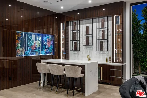 a kitchen with stainless steel appliances granite countertop a sink a stove and a refrigerator