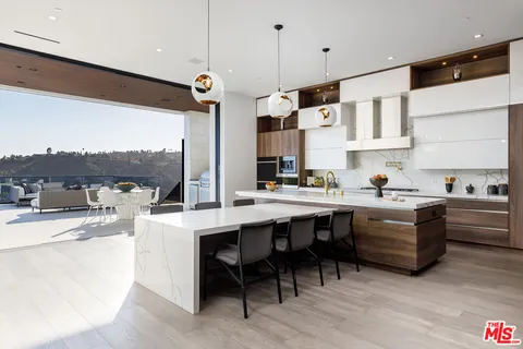 a kitchen with stainless steel appliances granite countertop a sink and white cabinets
