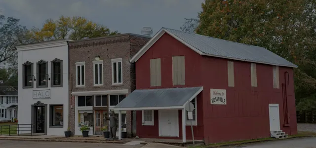 a front view of a house with glass windows and entryway