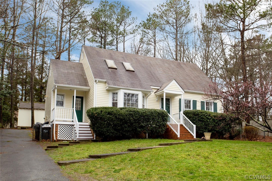 2624 Colgrave Road Midlothian, VA 23112 - Photo 1 of 29 a front view of a house with a garden and trees