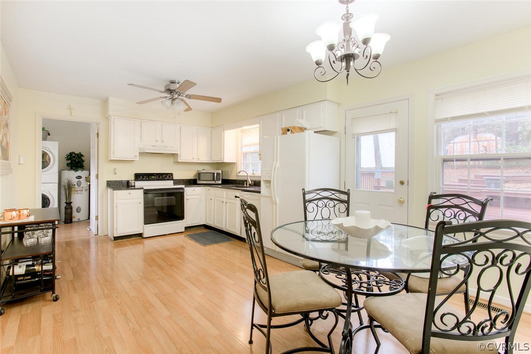 2624 Colgrave Road Midlothian, VA 23112 - Photo 8 of 29 a kitchen with stainless steel appliances granite countertop a dining table chairs stove and refrigerator