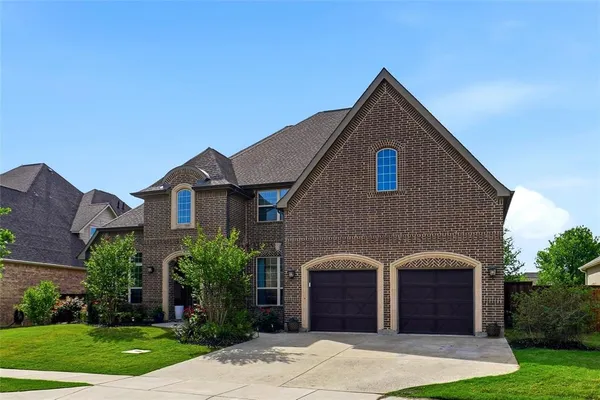 a front view of a house with yard and garage