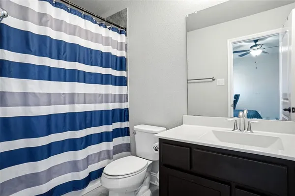 a bathroom with a sink a toilet a shower and a mirror