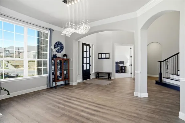 a view of a livingroom with wooden floor and windows