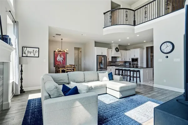 a living room with furniture and kitchen view