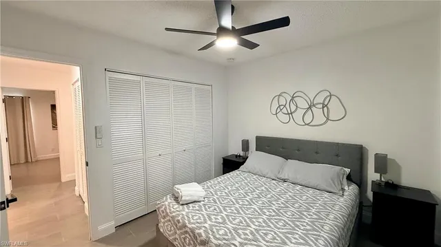 a bedroom with a large bed and a chandelier