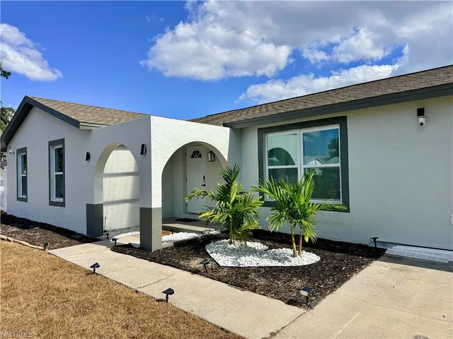 a front view of a house with garden
