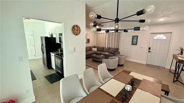 a living room with furniture a flat screen tv and a window