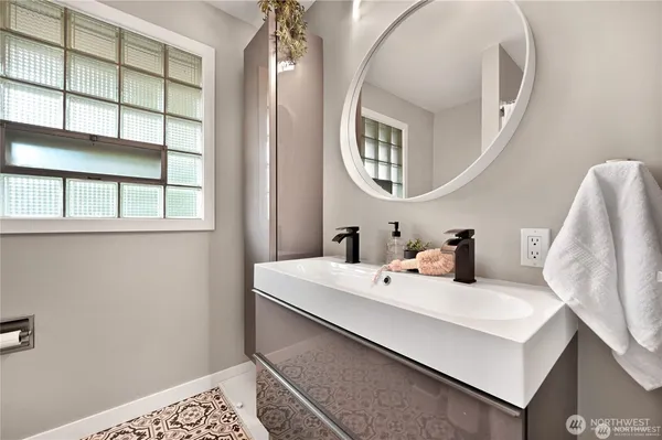a bathroom with a sink and a mirror