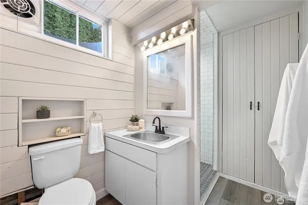 a bathroom with a toilet sink and mirror