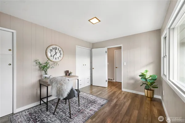 a view of a workspace room with furniture and wooden floor