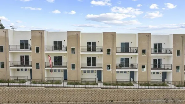 a front view of residential houses with street