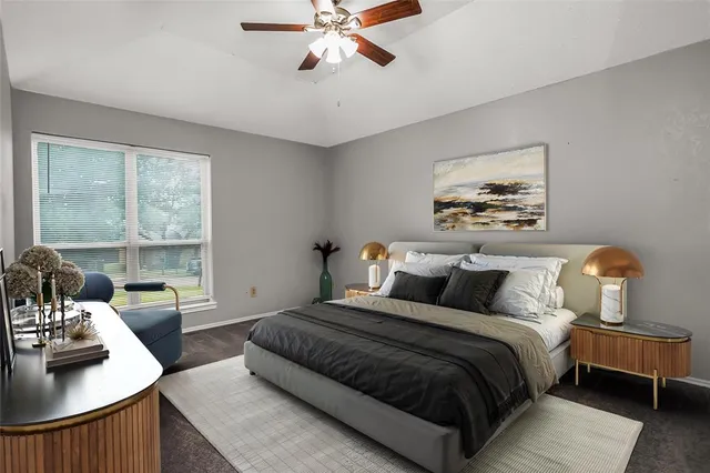 a bedroom with a bed couch and window