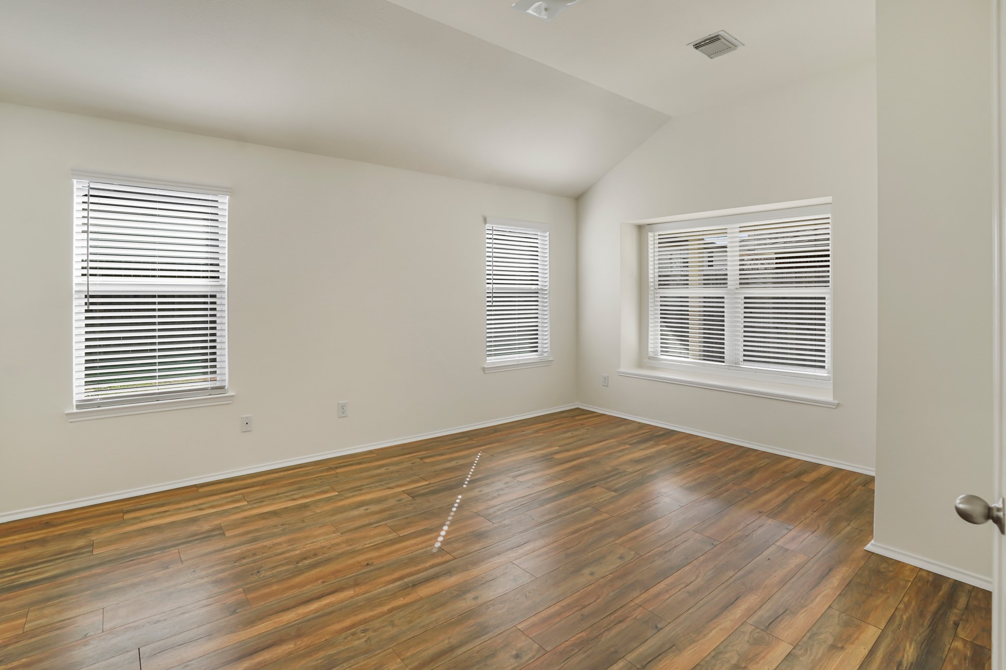 18531 Windy Village Lane Katy, TX 77449 - Photo 13 of 21 a view of an empty room with wooden floor and a window