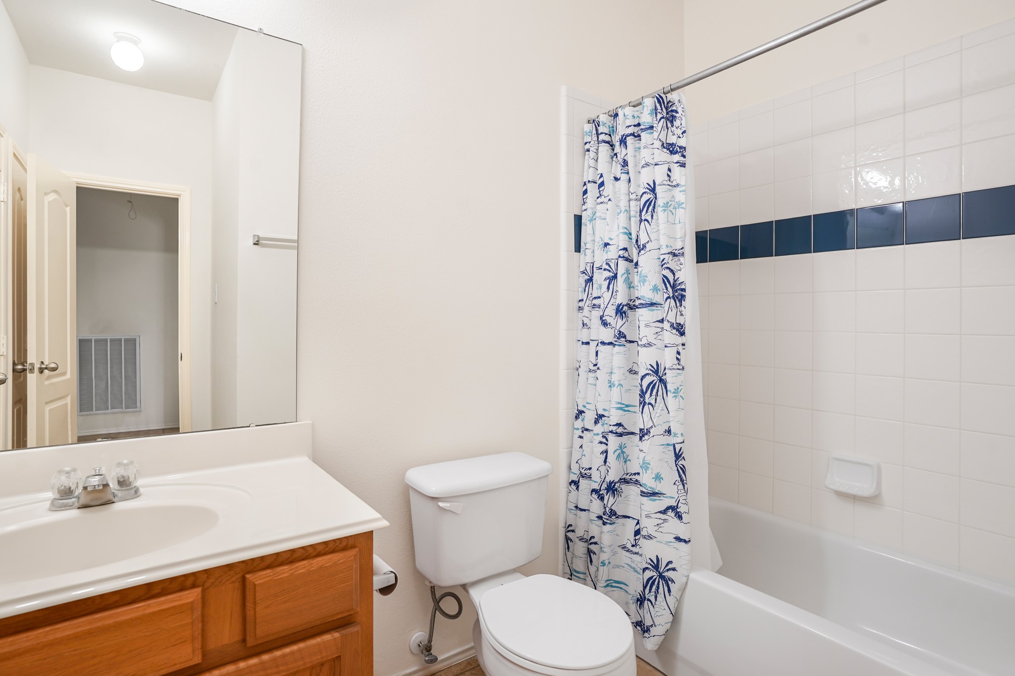 18531 Windy Village Lane Katy, TX 77449 - Photo 16 of 21 a bathroom with a sink a toilet and shower curtain