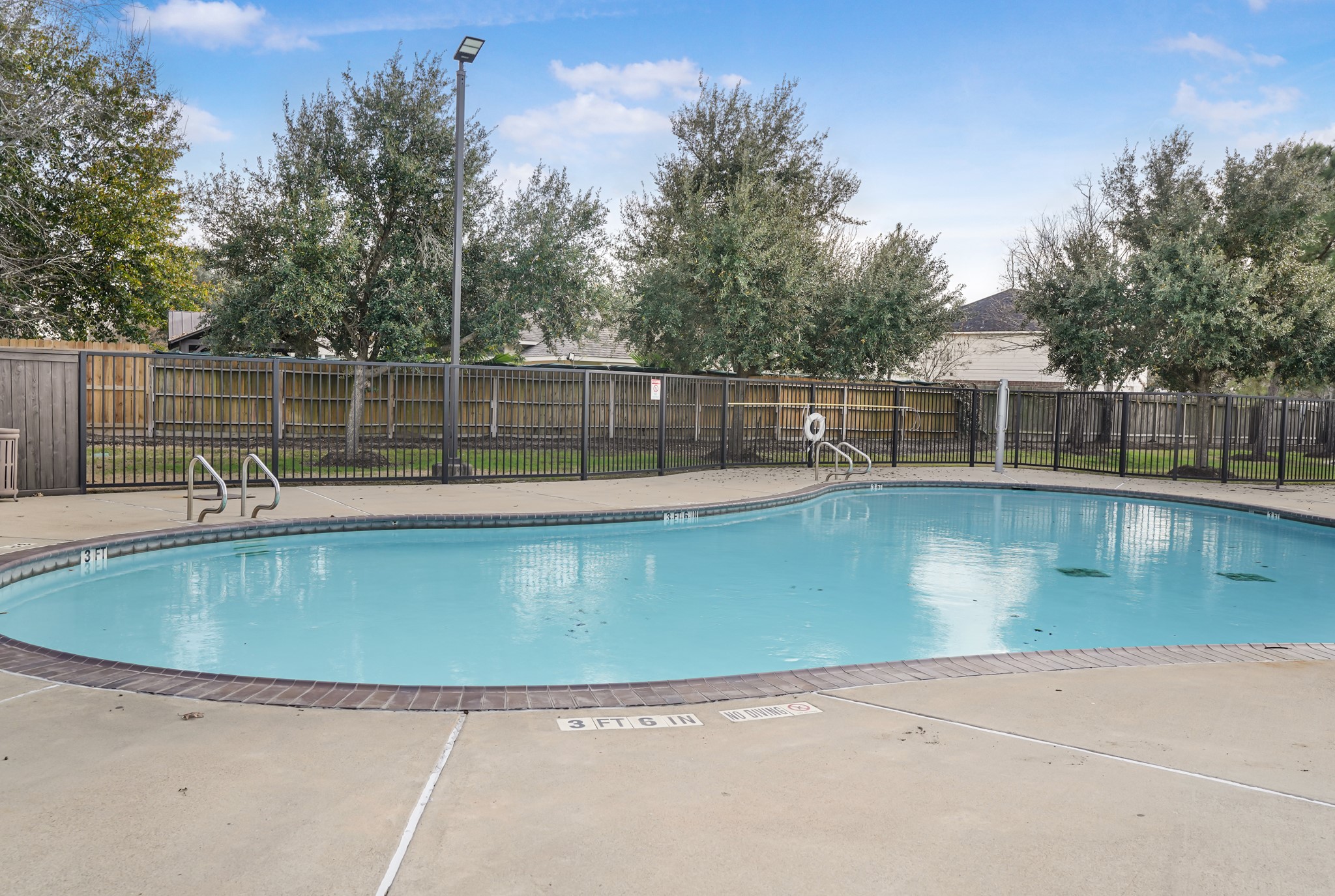 18531 Windy Village Lane Katy, TX 77449 - Photo 19 of 21 a view of a swimming pool with a patio