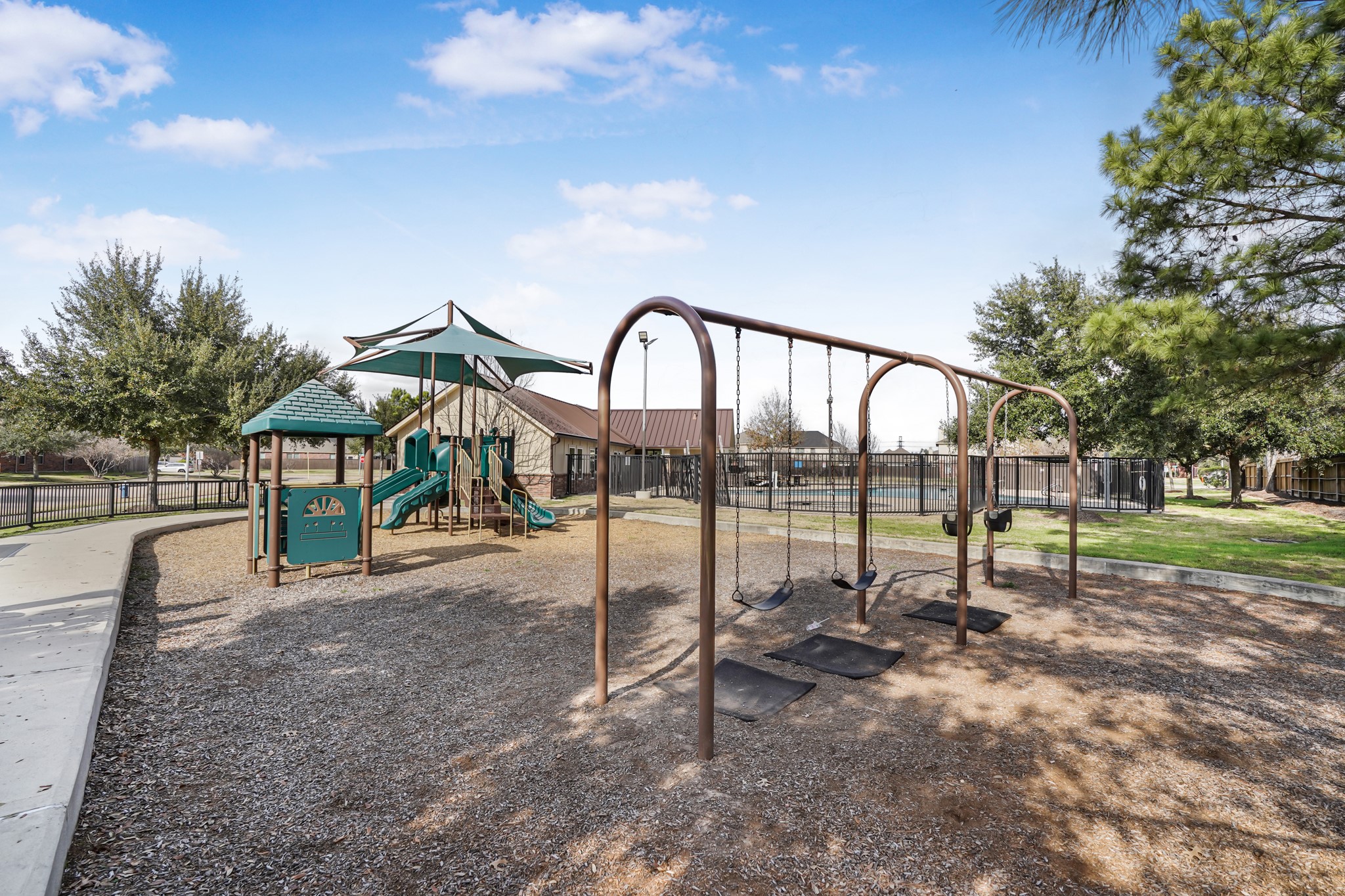 18531 Windy Village Lane Katy, TX 77449 - Photo 20 of 21 a view of a park with swings and slides