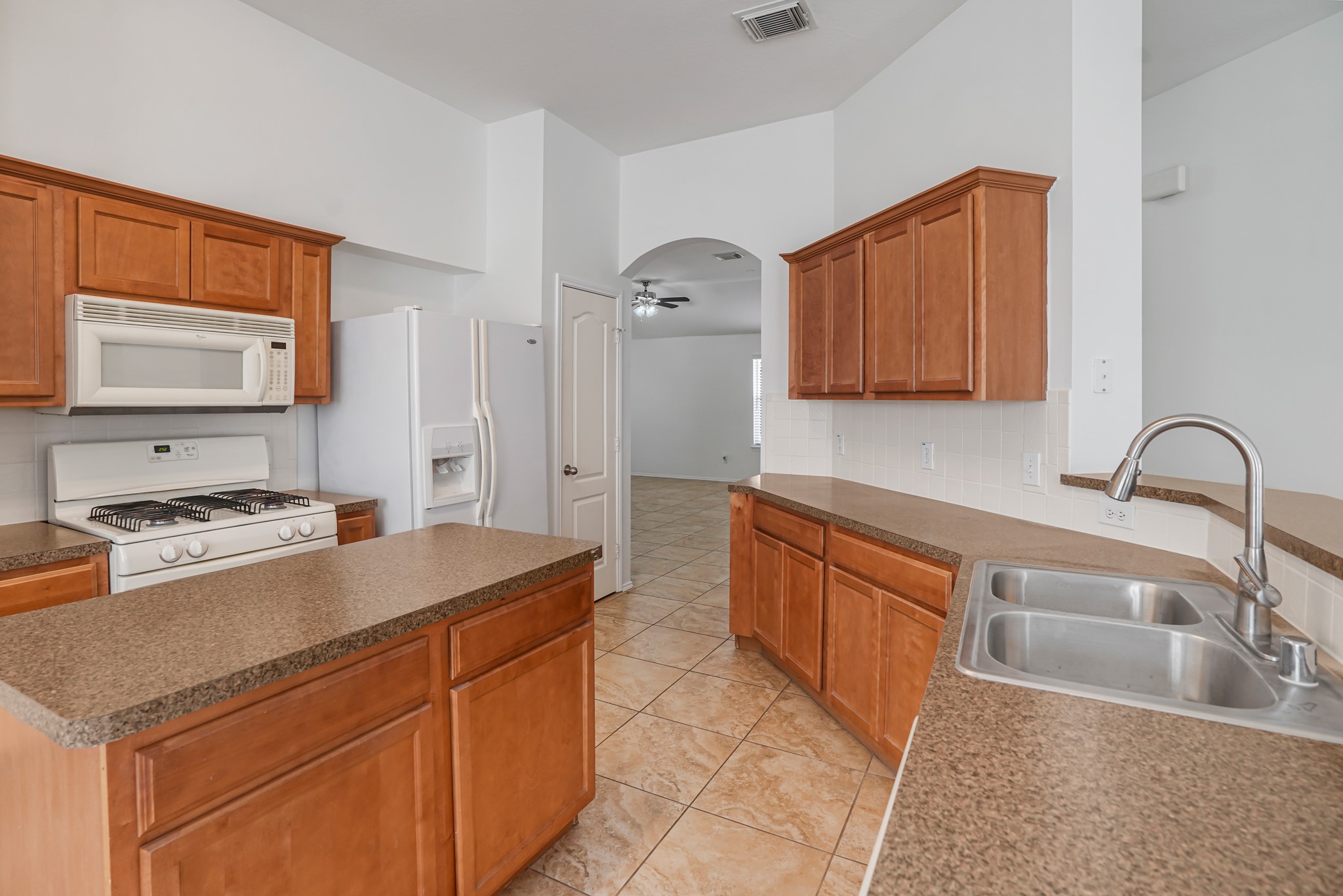 18531 Windy Village Lane Katy, TX 77449 - Photo 5 of 21 a kitchen with stainless steel appliances granite countertop a sink stove and refrigerator