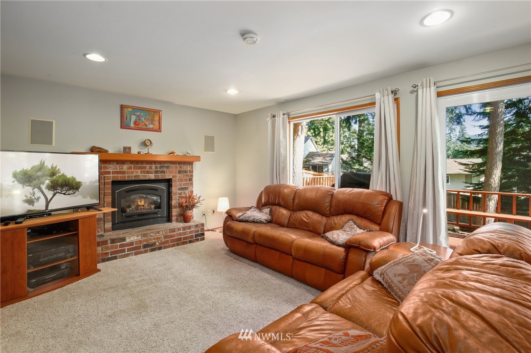 5030 Northeast 21st Street Renton, WA 98059 - Photo 10 of 27 a living room with furniture a large window and a fireplace