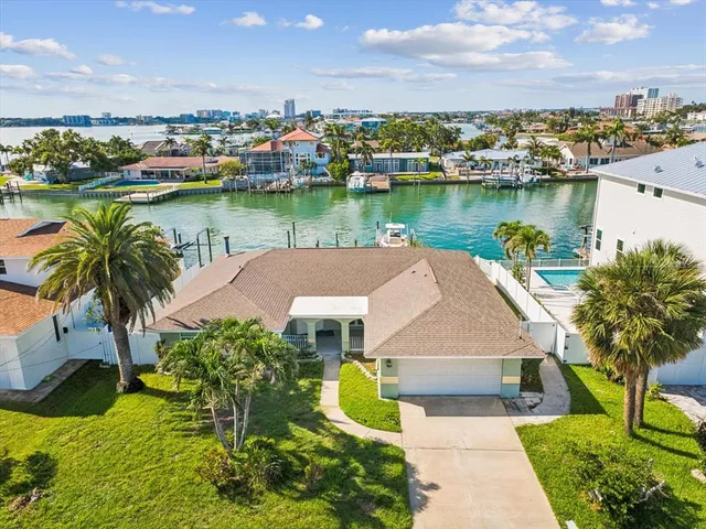 an aerial view of a house with outdoor space and lake view in back