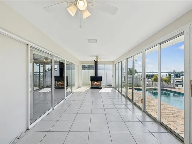a view of a refrigerator in kitchen and an empty room