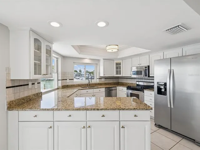 a kitchen with cabinets appliances and a counter space