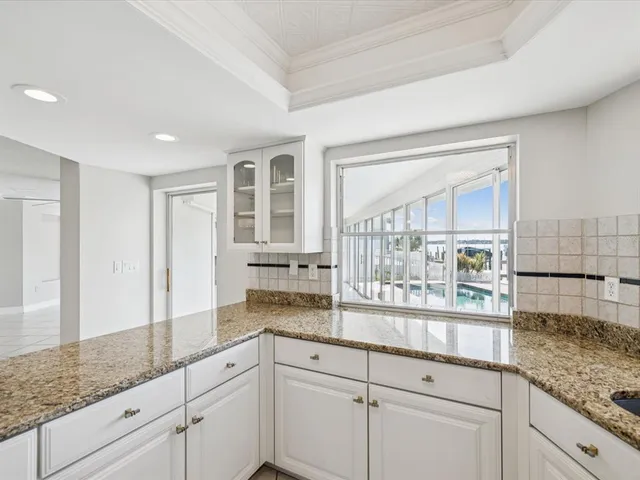 a view of an empty room with a window and a ceiling fan