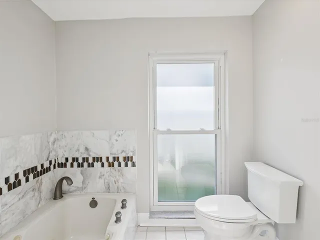 a view of a house with a swimming pool and sitting area