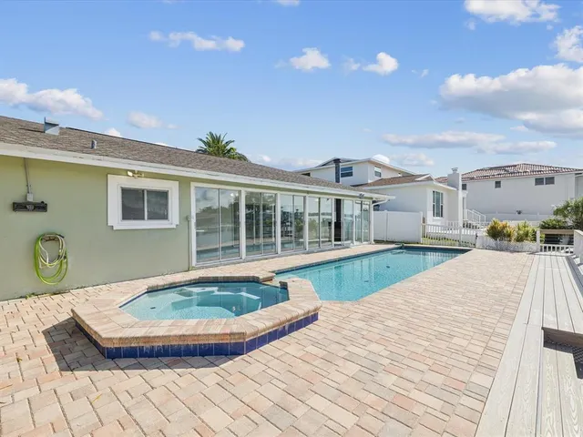 a view of a patio with table and chairs with wooden floor and fence